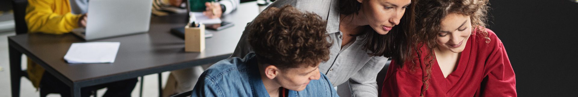 A man with curly hair sitting down.